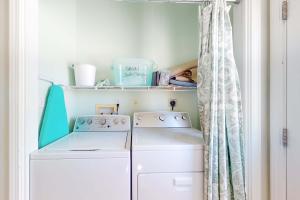 a laundry room with a washing machine and a shelf at Sun & Sea in Gulf Shores +19 photos