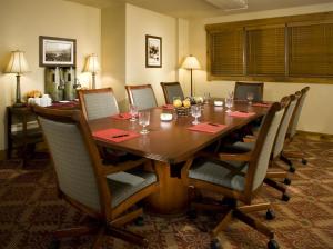 a dining room table with chairs and a long table at Mountain Thunder Lodge, A Vail Resorts Property in Breckenridge +155 photos