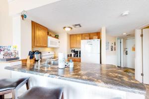 a kitchen with a counter top and a refrigerator at Plantation West #1354 in Gulf Shores