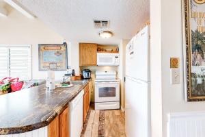 a kitchen with a white refrigerator and a counter at Plantation West #1354 in Gulf Shores