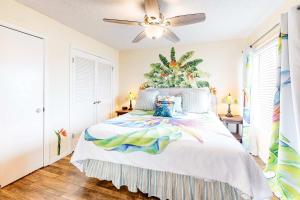 a bedroom with a bed with a ceiling fan at Plantation West #1354 in Gulf Shores +9 photos