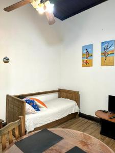 a bedroom with a bed and a desk with a laptop at La Escondida de Tigre in Tigre