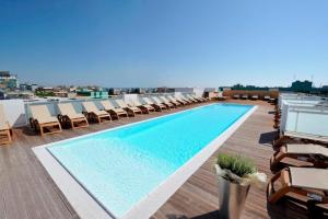 a swimming pool on the roof of a building at Hotel Luciana in Bibione