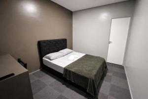 a bedroom with a bed in a room with a door at sleep airport congonhas in São Paulo