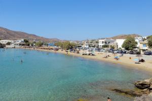 a beach with a bunch of people in the water at Giannis Papoutsis in Posidhonía