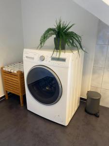 a washing machine with a plant on top of it at Fantastic apartment with unique panoramic views in Kuchl in Größing