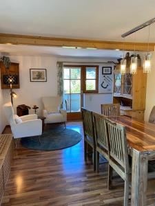 a living room with a table and chairs at Fantastic apartment with unique panoramic views in Kuchl in Größing