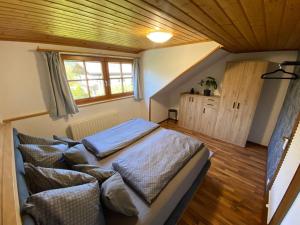 a bedroom with a bed with pillows on it at Fantastic apartment with unique panoramic views in Kuchl in Größing