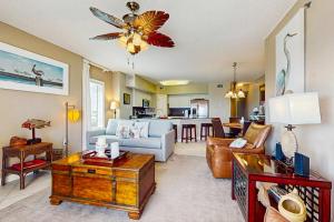 a living room with a couch and a table at Beachfront condo with shared pool outdoor shower and beach access in Gulf Shores