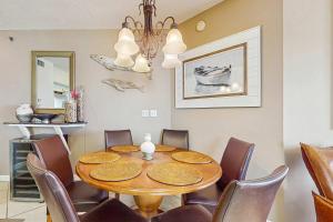 a dining room with a table and chairs at Beachfront condo with shared pool outdoor shower and beach access in Gulf Shores