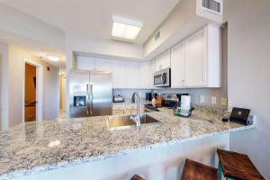 a kitchen with a sink and a counter top at Tidewater 601 in Orange Beach