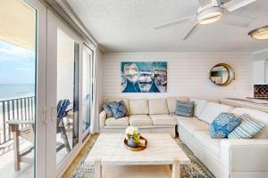 a living room with a couch and a table at Gulf-front condo with breathtaking views pool in Orange Beach
