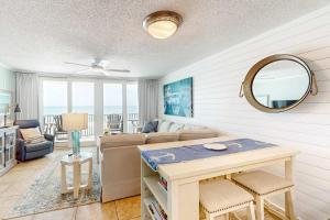 a living room with a couch and a table at Gulf-front condo with breathtaking views pool in Orange Beach +26 photos
