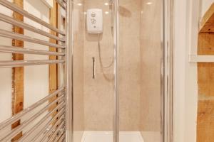 a shower with a glass door in a bathroom at Maldon Executive Apartments in Maldon +70 photos
