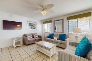 a living room with couches and a ceiling fan at The Whaler 7B in Gulf Shores