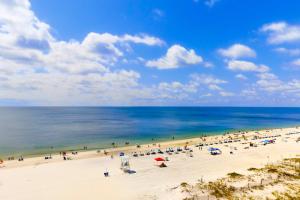 a group of people on a beach with the ocean at The Whaler 7B in Gulf Shores