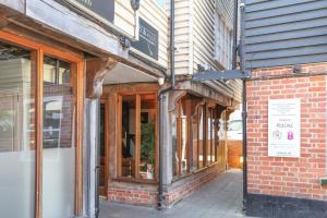 a store front of a brick building with windows at Maldon Executive Apartments in Maldon