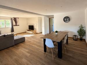 a living room with a table and a couch at Villa Patja in Béziers