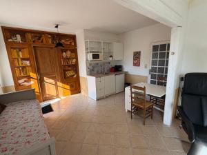 a kitchen with a table and a dining room at Mas des Fleurs in Châteaurenard