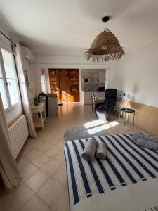 a bedroom with a bed and a living room at Mas des Fleurs in Châteaurenard