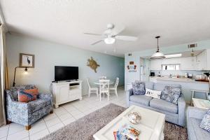 a living room with a couch and a tv at Beachfront Condo with Gorgeous Gulf View Balcony & Shared Pools in Orange Beach