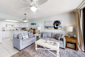 a living room with a couch and a table at Beachfront Condo with Gorgeous Gulf View Balcony & Shared Pools in Orange Beach