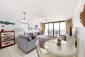 a living room with a couch and a table at Beachfront Condo with Gorgeous Gulf View Balcony & Shared Pools in Orange Beach +26 photos
