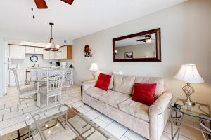 a living room with a couch and a table at Beachfront Condo with Gulf View Balcony WiFi AC & Shared Pools in Orange Beach
