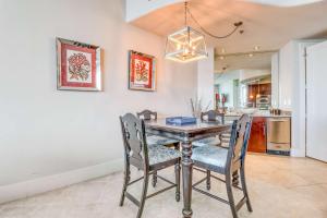 a dining room with a table and chairs at Bella Luna 1203 in Orange Beach +25 photos