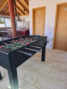 a large black foosball table in a room at Guest House Banana in Dubrovnik