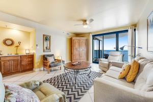 a living room with a couch and a table at Broadmoor 604 in Orange Beach