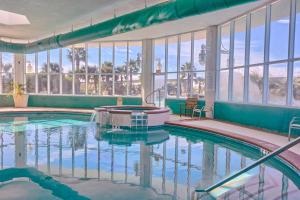 a swimming pool in a building with a large window at Caribe PHB12 in Orange Beach