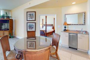 a kitchen and dining room with a table and chairs at Caribe PHB12 in Orange Beach