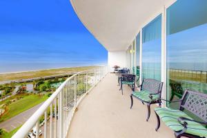 a balcony with chairs and a view of the ocean at Caribe PHB12 in Orange Beach