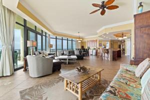 a living room with a couch and a table at Phoenix West 2601 in Orange Beach