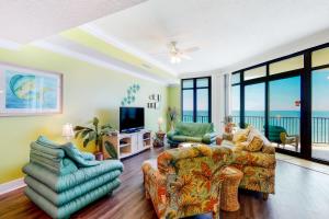 a living room with two couches and a television at Phoenix West 502 in Orange Beach