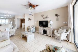 a living room with a couch and a tv at Pelican Pointe 302 in Orange Beach