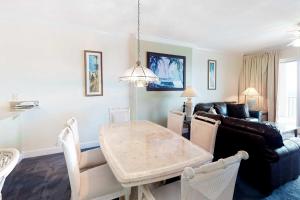 a living room with a table and a couch at Regency Isle 805 in Orange Beach