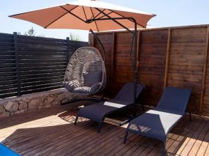 a couple of chairs and an umbrella on a deck at Villa Maris in Demre