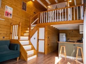 a wooden cabin with a staircase and a blue couch at Villa Maris in Demre