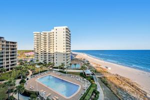 an aerial view of a building and the beach at Fantastic condo with elevator WiFi & central AC - beachfront Location in Orange Beach