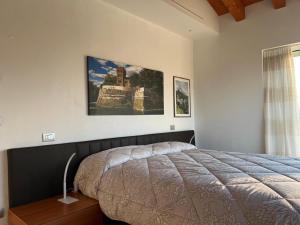 a bedroom with a bed and a picture on the wall at Dolce Vita in Altivole