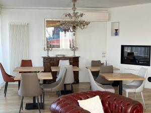 a dining room with tables and a couch at Dolce Vita in Altivole