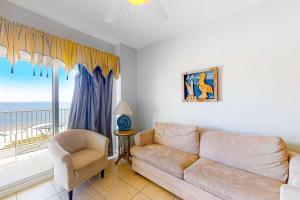 a living room with a couch and a window at Tidewater 908 in Orange Beach