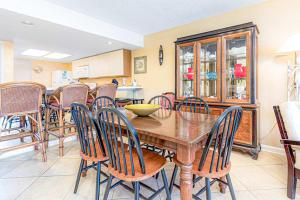 a dining room with a wooden table and chairs at Wind Drift 311S in Orange Beach