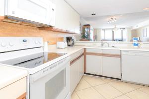a kitchen with white appliances and a sink at Wind Drift 311S in Orange Beach +20 photos