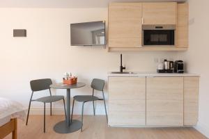 a small kitchen with a table and two chairs at Check In Belfast in Belfast +54 photos