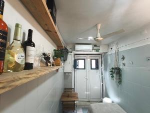 a room with bottles of wine on a shelf at Estúdio Madragoa in Lisbon +47 photos