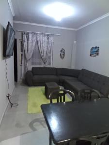 a living room with a couch and a table at Cozy suburban guest house - Durban in Verulam
