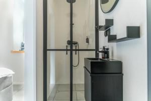 a bathroom with a sink and a shower at Rezidence 14 Nový Bor in Nový Bor